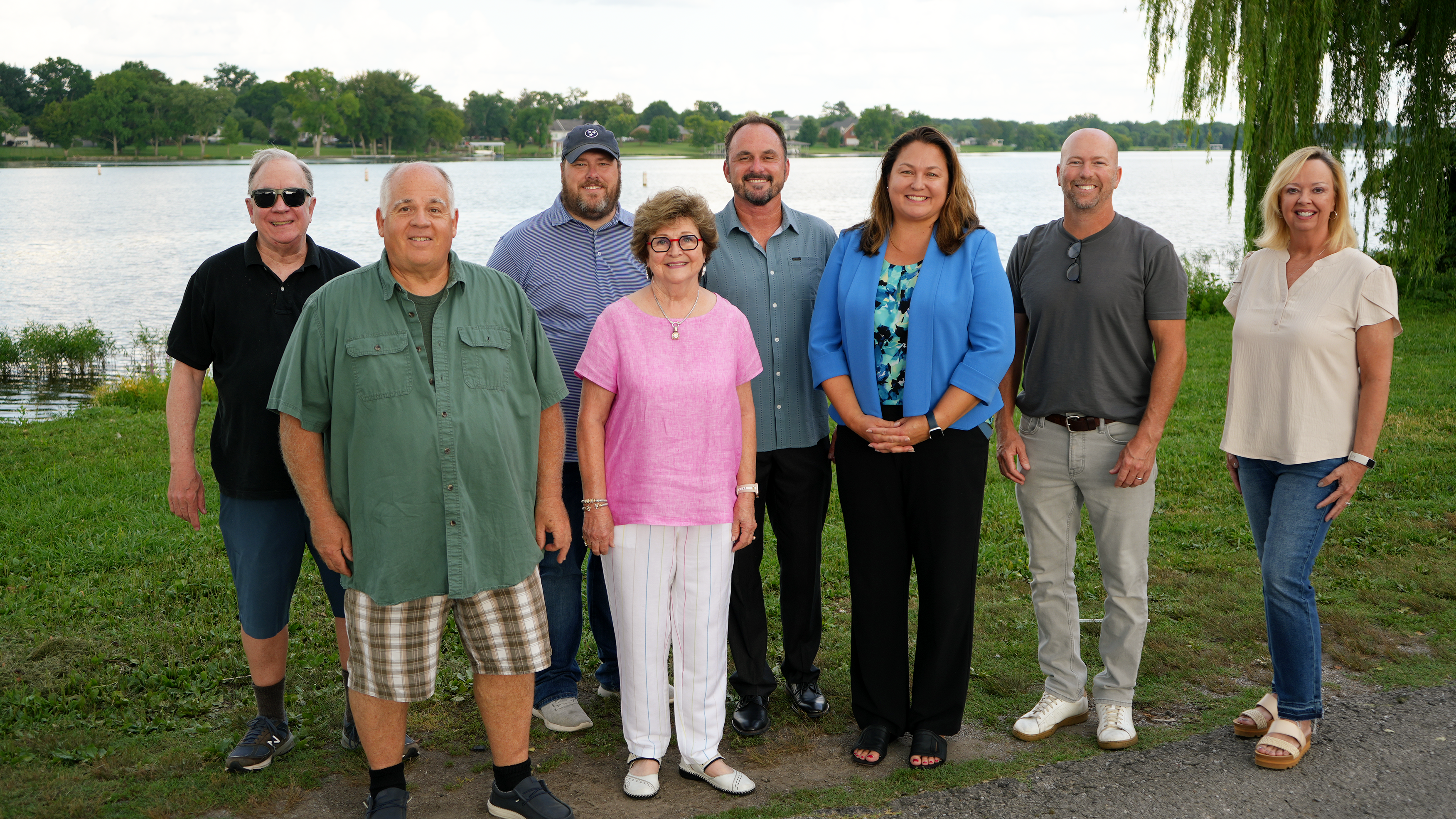 A photo of the lakeshore committee standing in front of the lake and smiling.